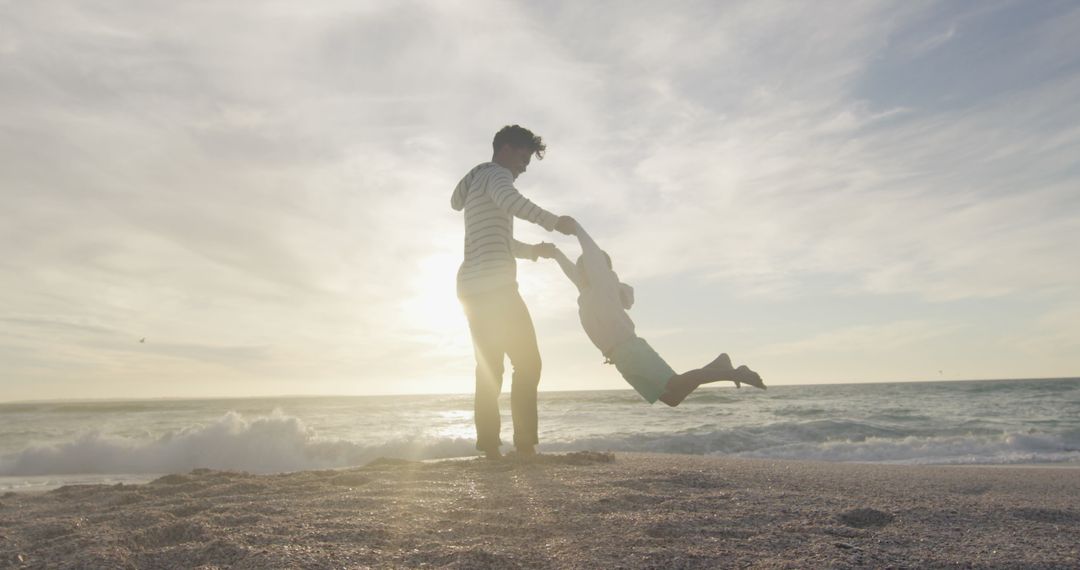 Father and Son Playing on Beach at Sunset Creating Unforgettable Moments