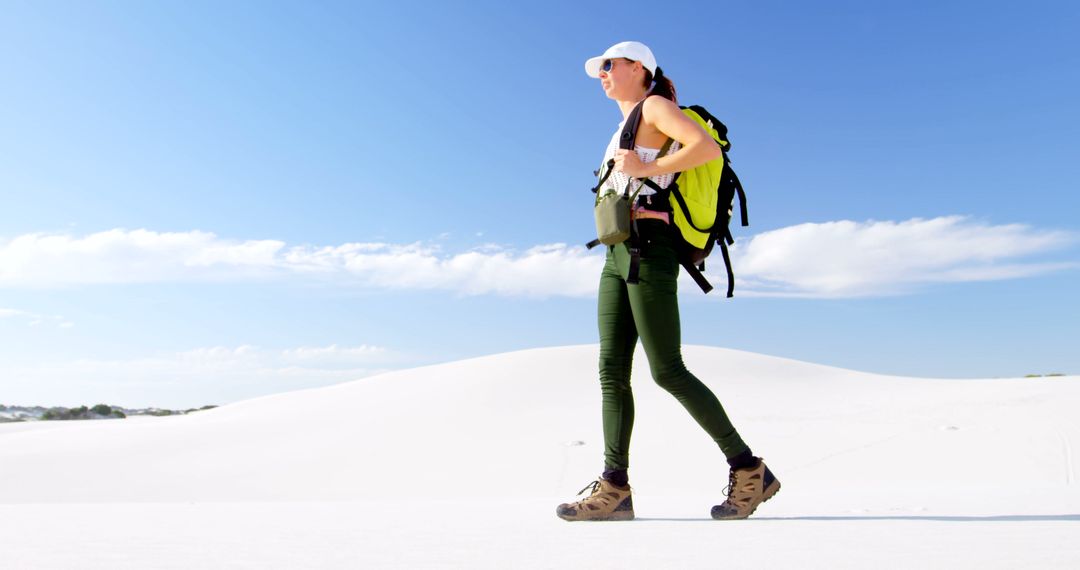 Woman Hiking in Desert with Mountains on Horizon on Sunny Day - Free Images, Stock Photos and Pictures on Pikwizard.com