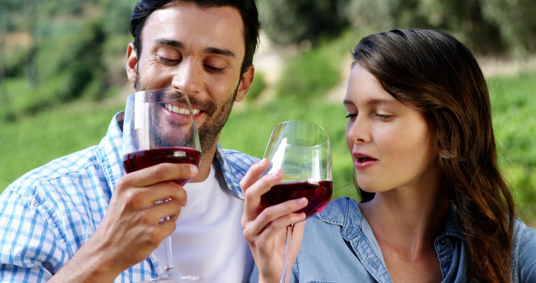 Happy Couple Relaxing with Red Wine in Vineyard - Free Images, Stock Photos and Pictures on Pikwizard.com