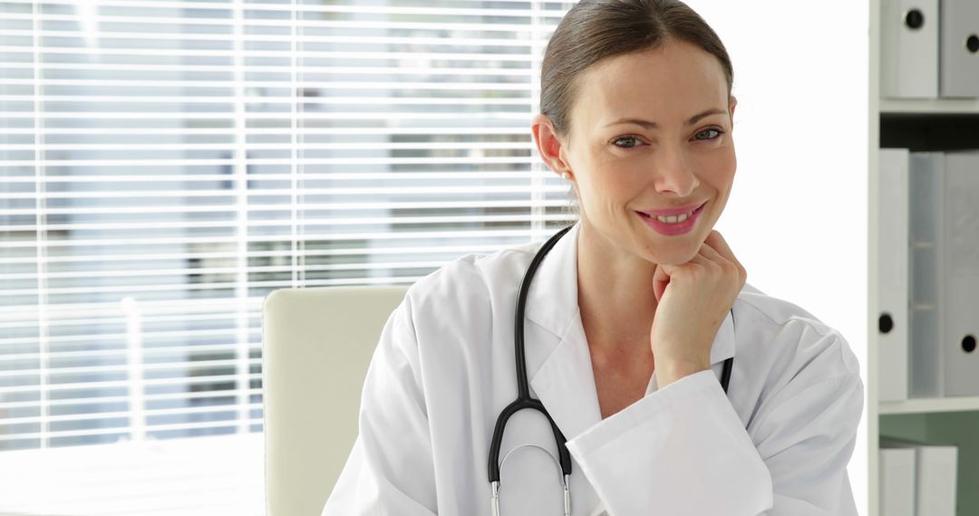 Smiling Female Doctor in White Coat with Stethoscope in Office - Free Images, Stock Photos and Pictures on Pikwizard.com