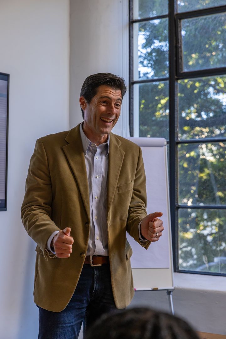 Confident Businessman Presenting at Office Meeting