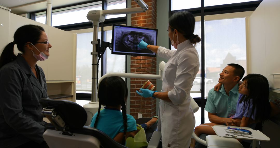 Dentist Explaining X-ray Results to Family with Children in Clinic - Free Images, Stock Photos and Pictures on Pikwizard.com