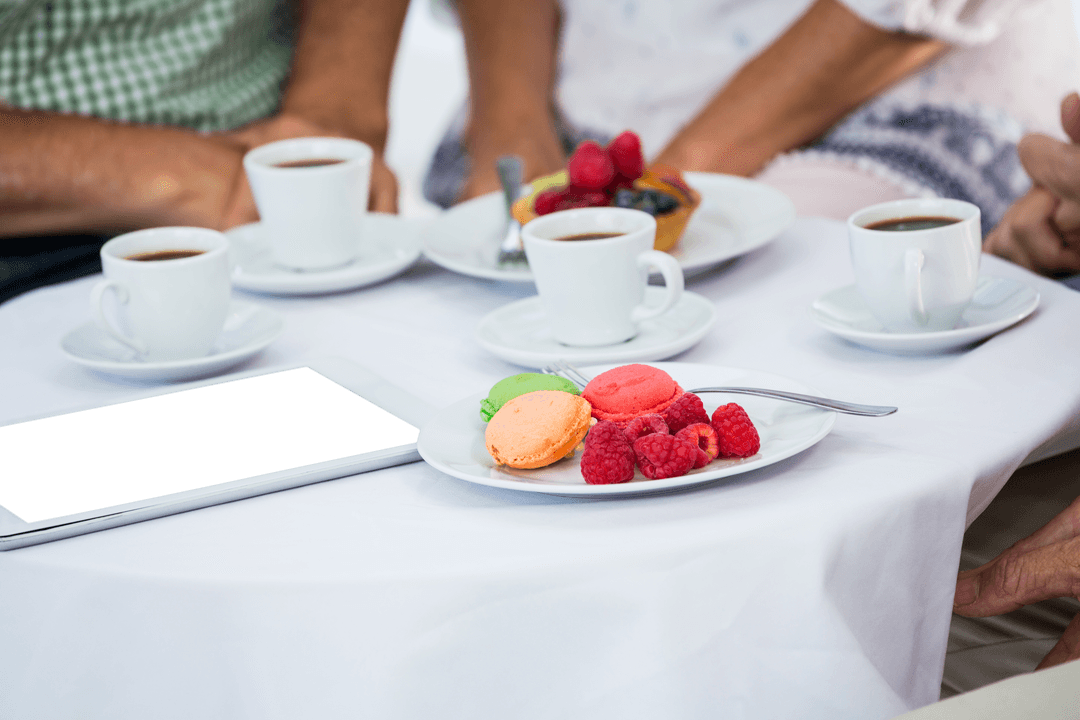 Expertly Arranged Transparent Macarons and Coffee Meeting