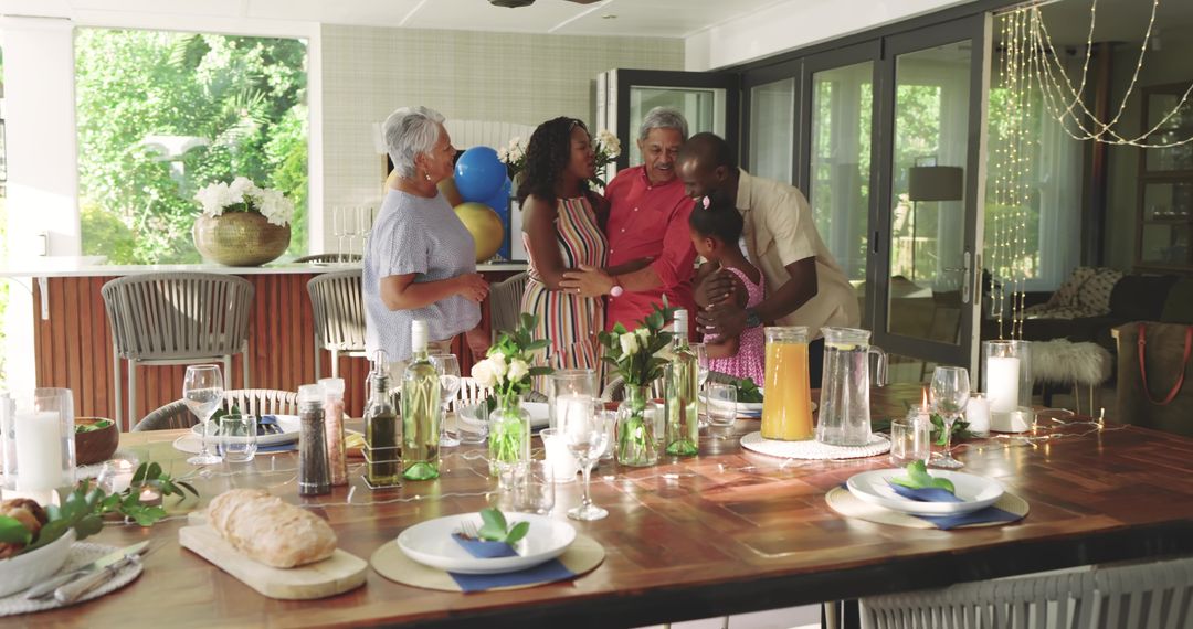 Multigenerational diverse family celebrating together in sunlit kitchen with dining table