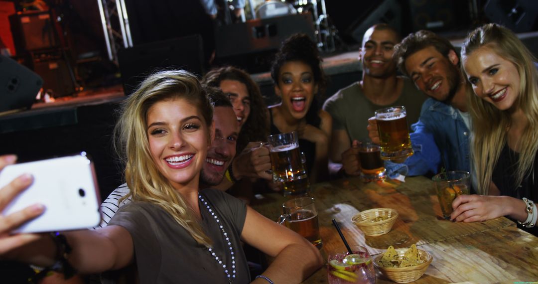 Diverse Friends Enjoying Night Out with Drinks in a Bar