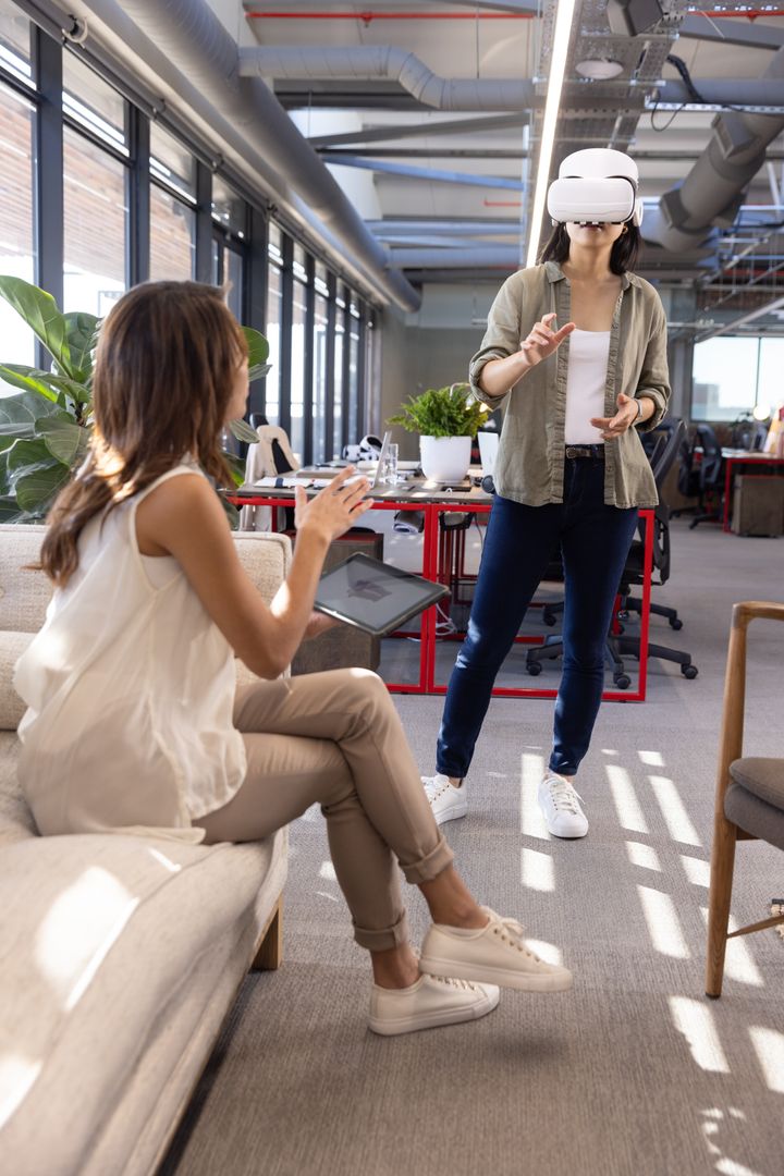 Colleagues Testing VR Headset in Contemporary Office Environment