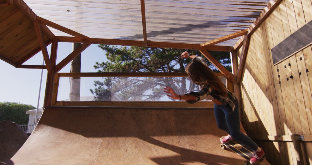 Teenage Girl Skateboarding Indoors on a Wooden Ramp in Plaid Shirt - Free Images, Stock Photos and Pictures on Pikwizard.com