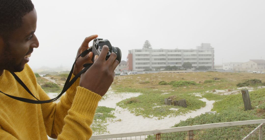 Young Man Capturing Scenic Landscape with DSLR Camera - Free Images, Stock Photos and Pictures on Pikwizard.com