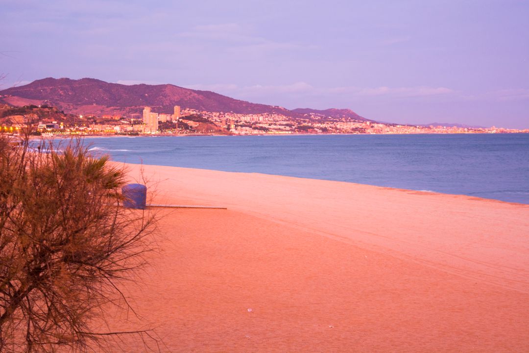 Beautiful Beachscape at Sunset with Mountains and City Skyline - Free Images, Stock Photos and Pictures on Pikwizard.com