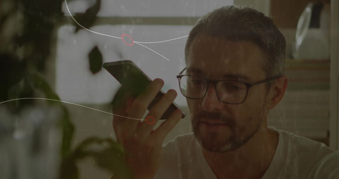 Man Speaking to Smartphone at Home Surrounded by Plants and Modern Decor
