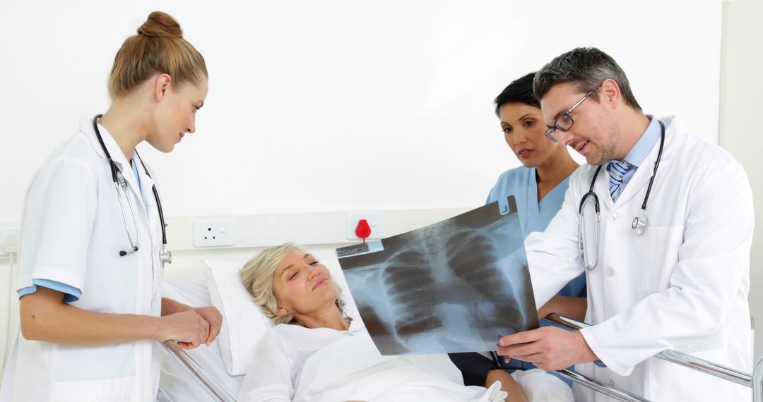 Doctors Examining Chest X-Ray with Patient in Hospital Bed - Free Images, Stock Photos and Pictures on Pikwizard.com