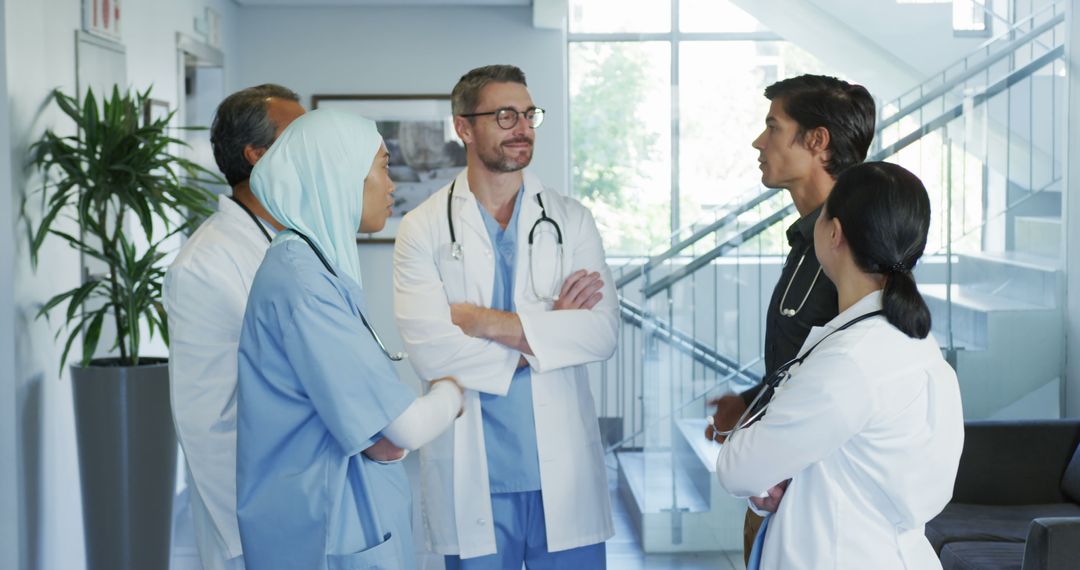 Diverse Medical Team Discussing in Hospital Hallway - Free Images, Stock Photos and Pictures on Pikwizard.com