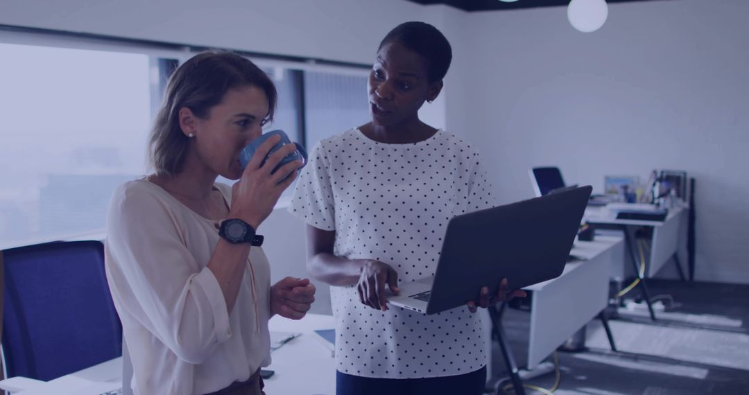 Colleagues Collaborating in Modern Office with Technology and Focus