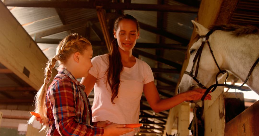 Young Girl and Woman Bonding While Feeding Horse Carrots in Stable - Free Images, Stock Photos and Pictures on Pikwizard.com