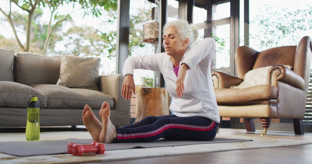 Senior Woman Practicing Yoga Indoors on a Mat - Free Images, Stock Photos and Pictures on Pikwizard.com