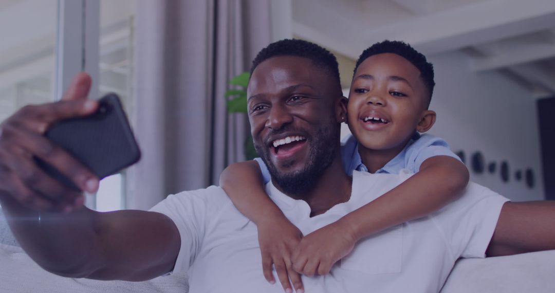 Happy Father and Son Taking Selfie at Home