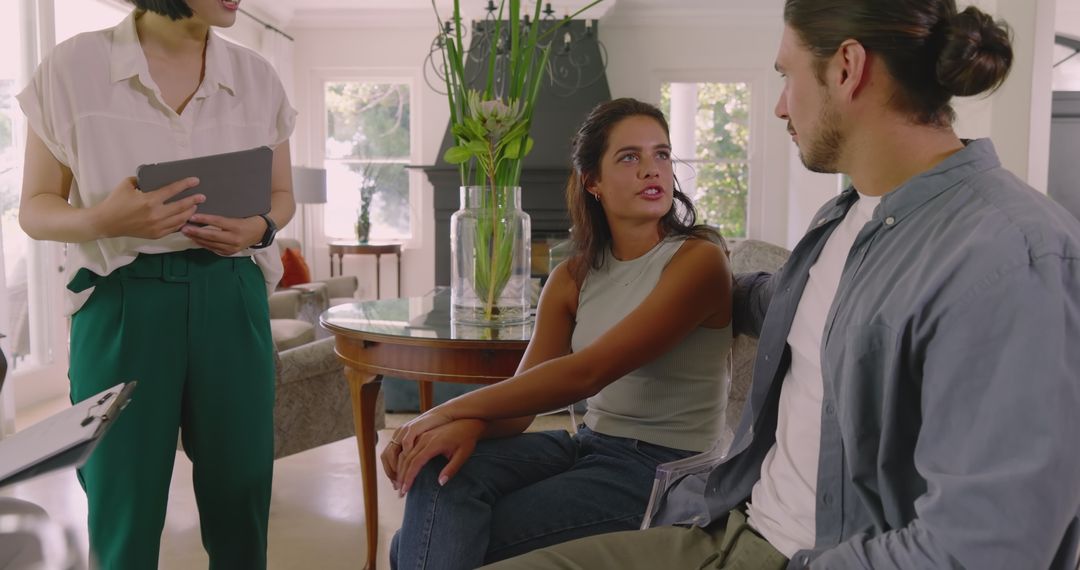 Couple Consulting with Professionals at Home for Event Planning