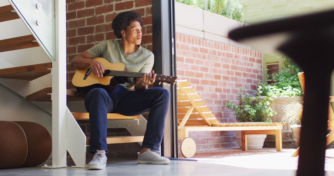 Man Playing Guitar and Singing in Cozy Modern Home
