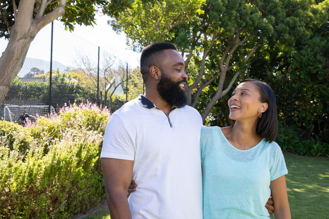 Couple Embracing in Sunlit Park Enjoying Connection and Nature