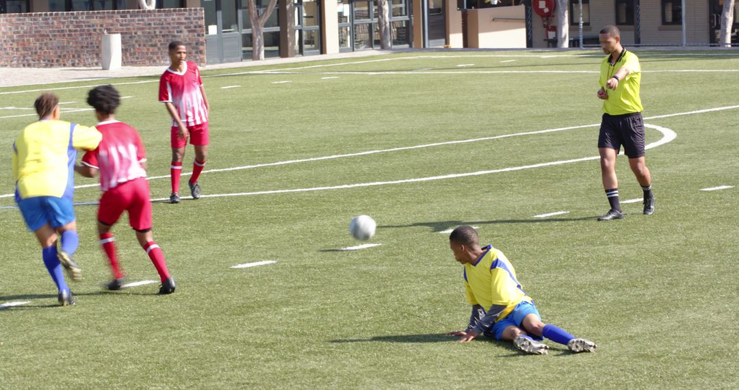 Youth Soccer Match with Players in Colorful Uniforms on School Field