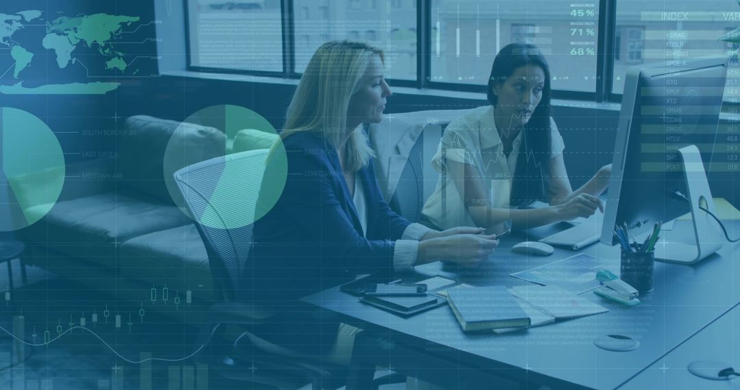 Cooperative Businesswomen Analyzing Data at Computer Desk