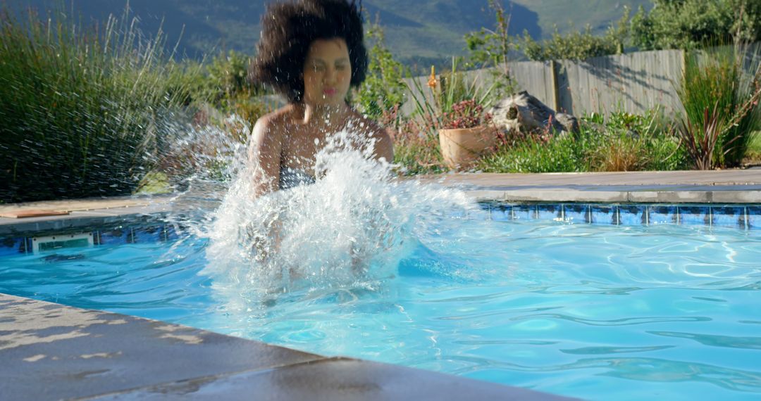 Woman Splashing in Outdoor Swimming Pool on Sunny Day - Free Images, Stock Photos and Pictures on Pikwizard.com