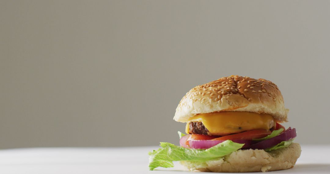 Close-Up of Tasty Cheeseburger with Fresh Vegetables on White Background - Free Images, Stock Photos and Pictures on Pikwizard.com