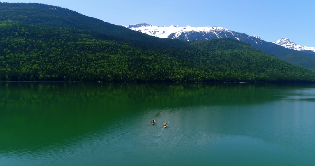 Scenic Lake with Kayakers and Snow-Capped Mountains - Free Images, Stock Photos and Pictures on Pikwizard.com