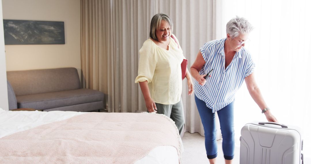 Senior Lesbian Couple Preparing Bags for Vacation in Bedroom