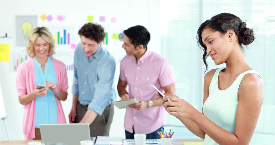 Diverse Professionals Collaborating with Digital Devices in Office