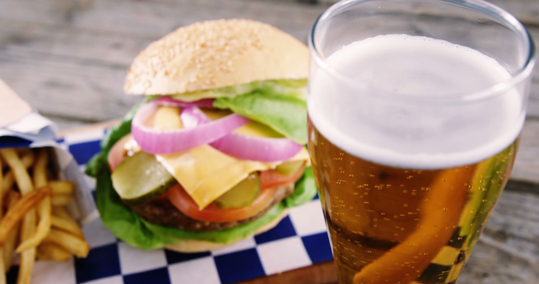 Close-Up of Tasty Cheeseburger with Glass of Refreshing Beer - Free Images, Stock Photos and Pictures on Pikwizard.com