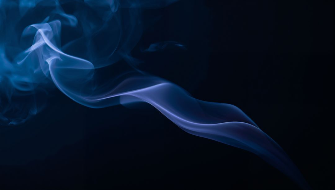 Curling blue-violet smoke ribbon flowing across deep black backdrop with teal highlights