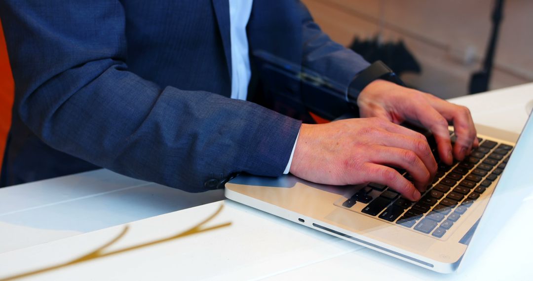 Businessman Typing on Laptop at Desk - Free Images, Stock Photos and Pictures on Pikwizard.com