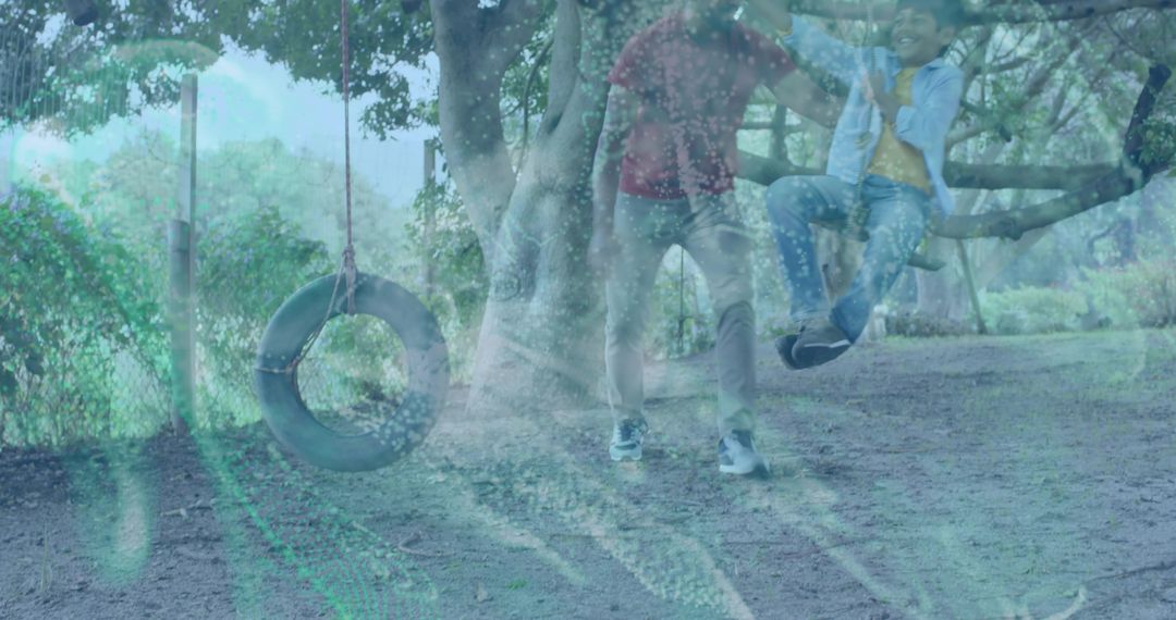 Guardian Watching Child Playing on Low Tree Branch with Tire Swing in Park