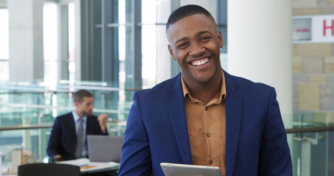 Smiling Businessman Holding Tablet in Modern Office - Free Images, Stock Photos and Pictures on Pikwizard.com