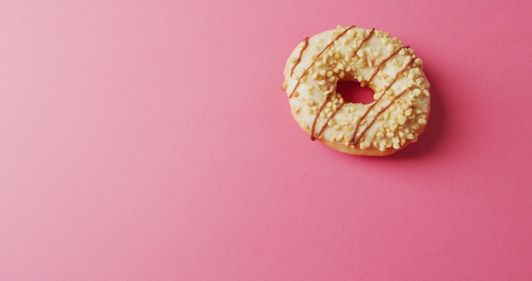 Donut with Nuts and Pink Glaze on Pink Background - Free Images, Stock Photos and Pictures on Pikwizard.com