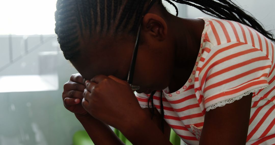 Young Girl in Distress with Striped Shirt and Braids - Free Images, Stock Photos and Pictures on Pikwizard.com