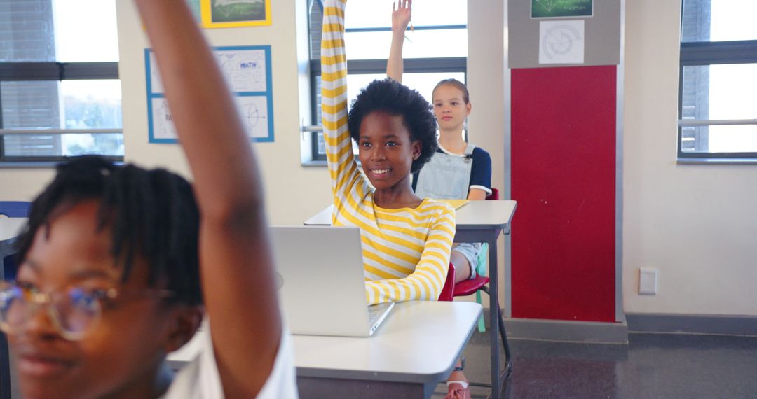 Attentive Students Raising Hands in Modern Classroom