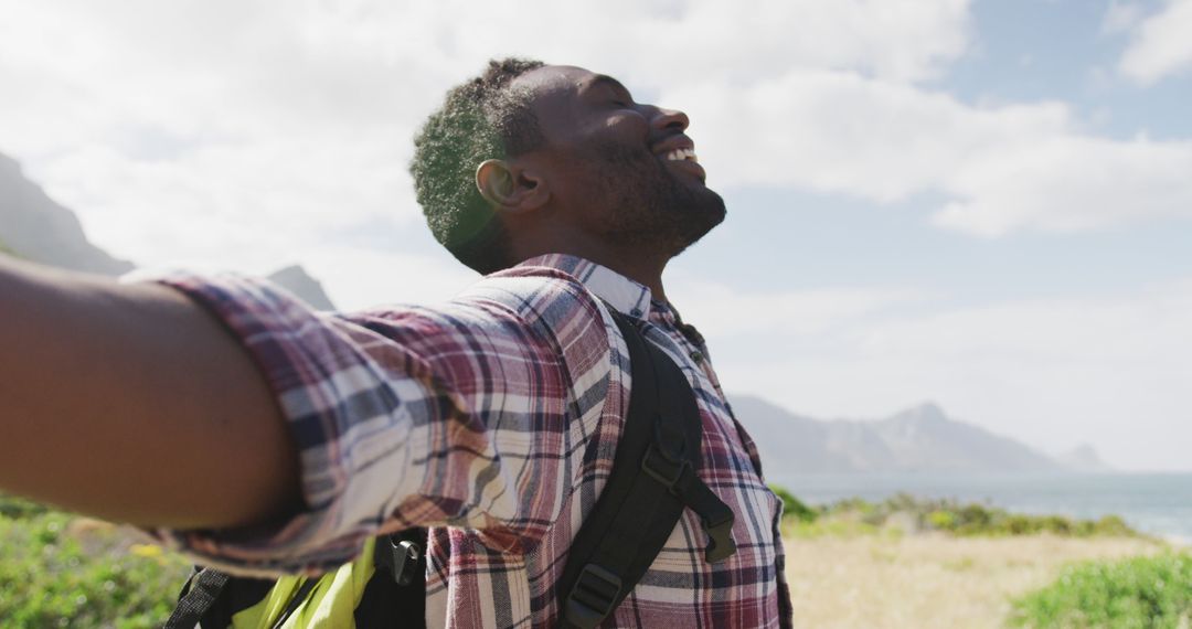 Man Embracing Freedom in Mountain Trekking Adventure