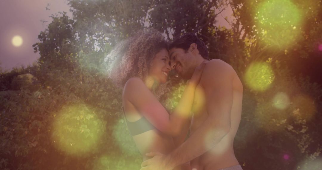 Sunlit Romantic Couple Embracing in Forest with Warm Golden Bokeh Glow