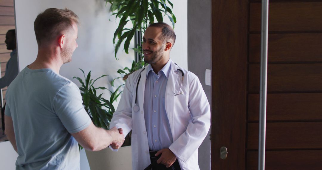 Friendly Doctor Greeting Patient with Handshake at Modern Clinic - Free Images, Stock Photos and Pictures on Pikwizard.com