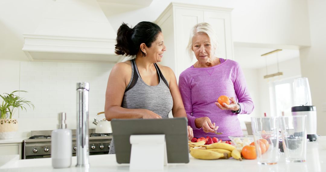 Two Women Enjoying Healthy Cooking Indoors - Free Images, Stock Photos and Pictures on Pikwizard.com