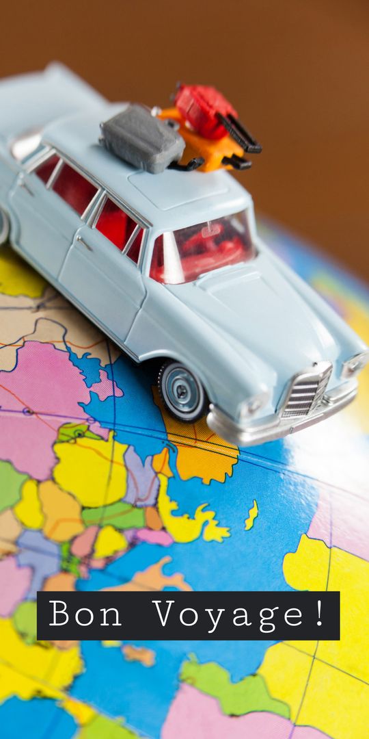 Miniature Car on World Map Reflecting Travel Adventures