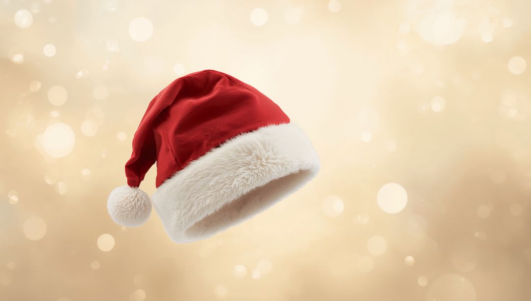 Floating Santa Hat with Plush White Trim on Warm Golden Bokeh Background