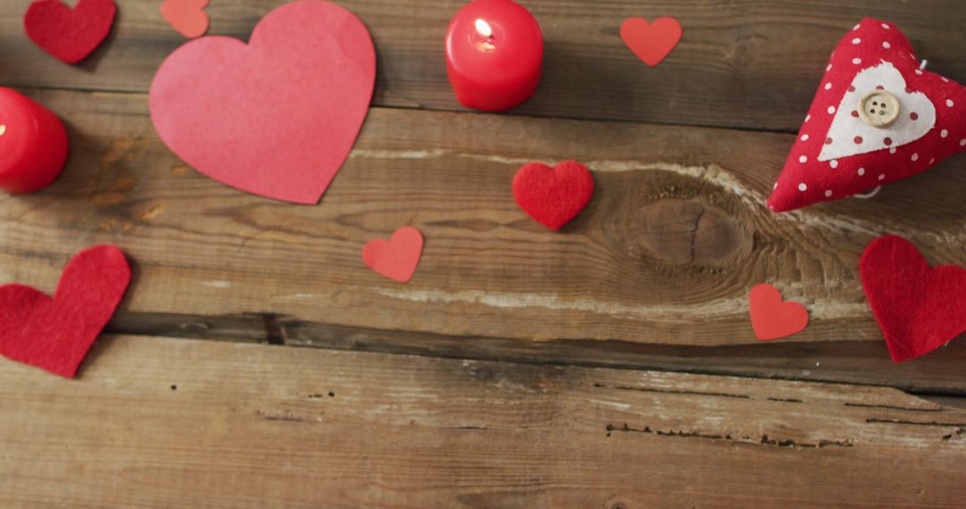 Romantic Decoration with Paper Hearts and Candles on Rustic Wooden Table