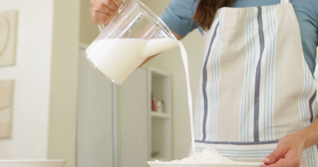 Woman Pouring Milk into Flour Batter Cooking Baking Preparation - Free Images, Stock Photos and Pictures on Pikwizard.com