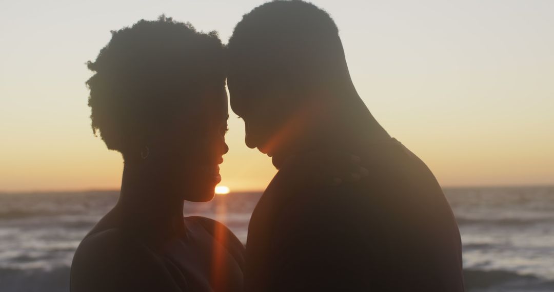 Romantic Couple Embracing During Sunset on Beach - Free Images, Stock Photos and Pictures on Pikwizard.com