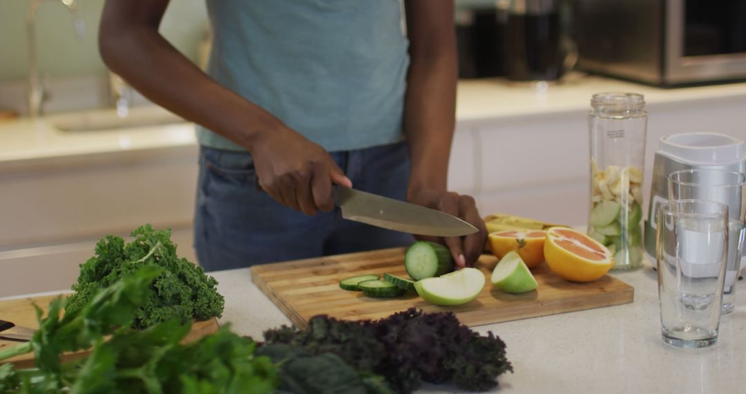 Close-Up of Person Slicing Fresh Vegetables and Fruit in Modern Kitchen - Free Images, Stock Photos and Pictures on Pikwizard.com