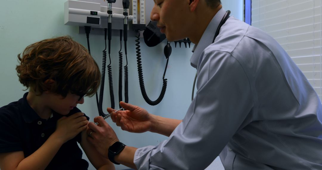 Doctor Vaccinating Young Boy in Clinic - Free Images, Stock Photos and Pictures on Pikwizard.com