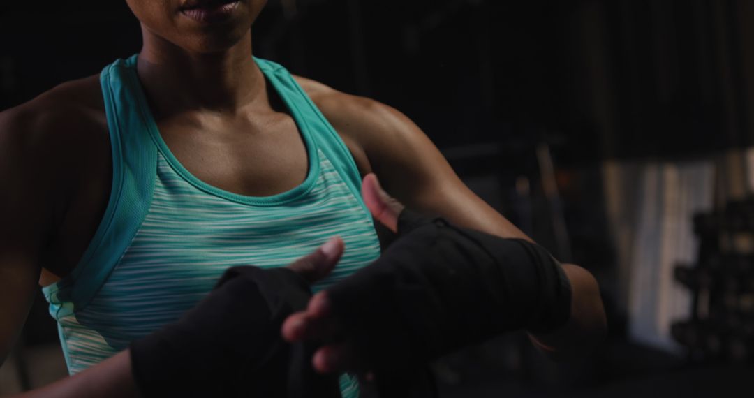 Determined Athlete Unwrapping Hands After Intense Boxing Workout